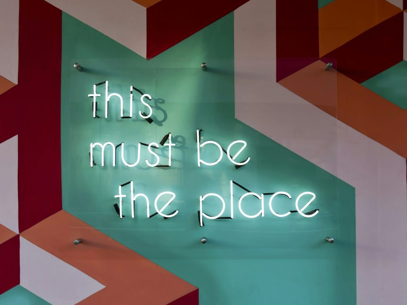 Note with misspelled text "Its Because we care" on a wooden surface, surrounded by foliage.